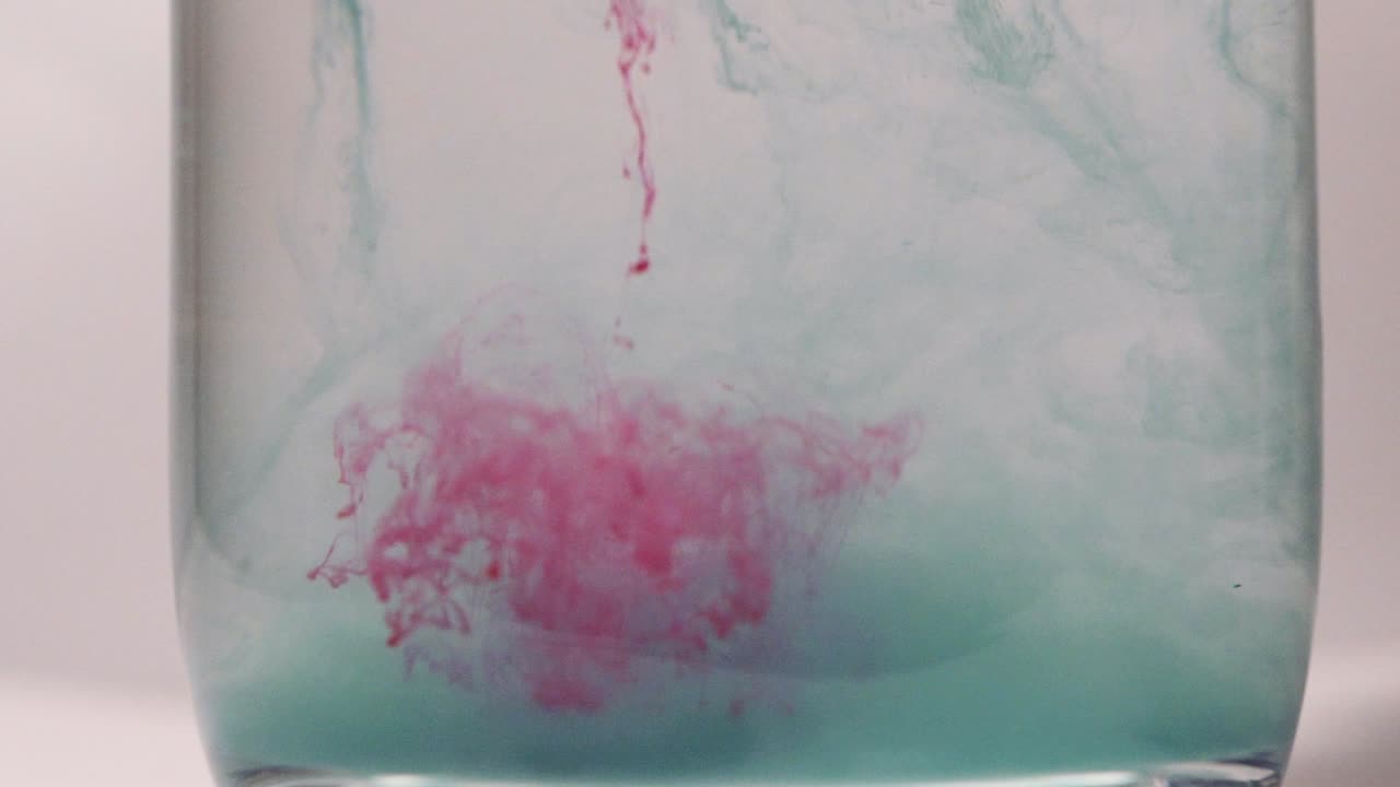 Red paint dissolving in water shot in slow motion with Sony a7iii.