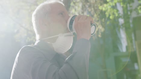 caucasian man out and about in the street wearing on a face mask against coronavirus