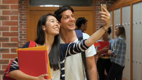 Happy-students-taking-selfie-in-locker-room