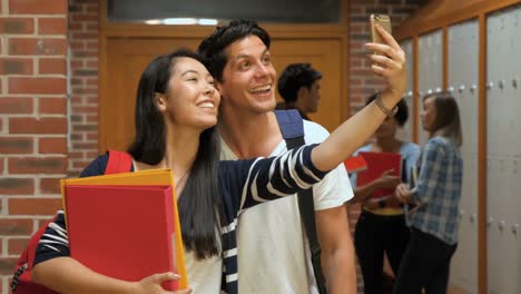 happy students taking selfie in locker room