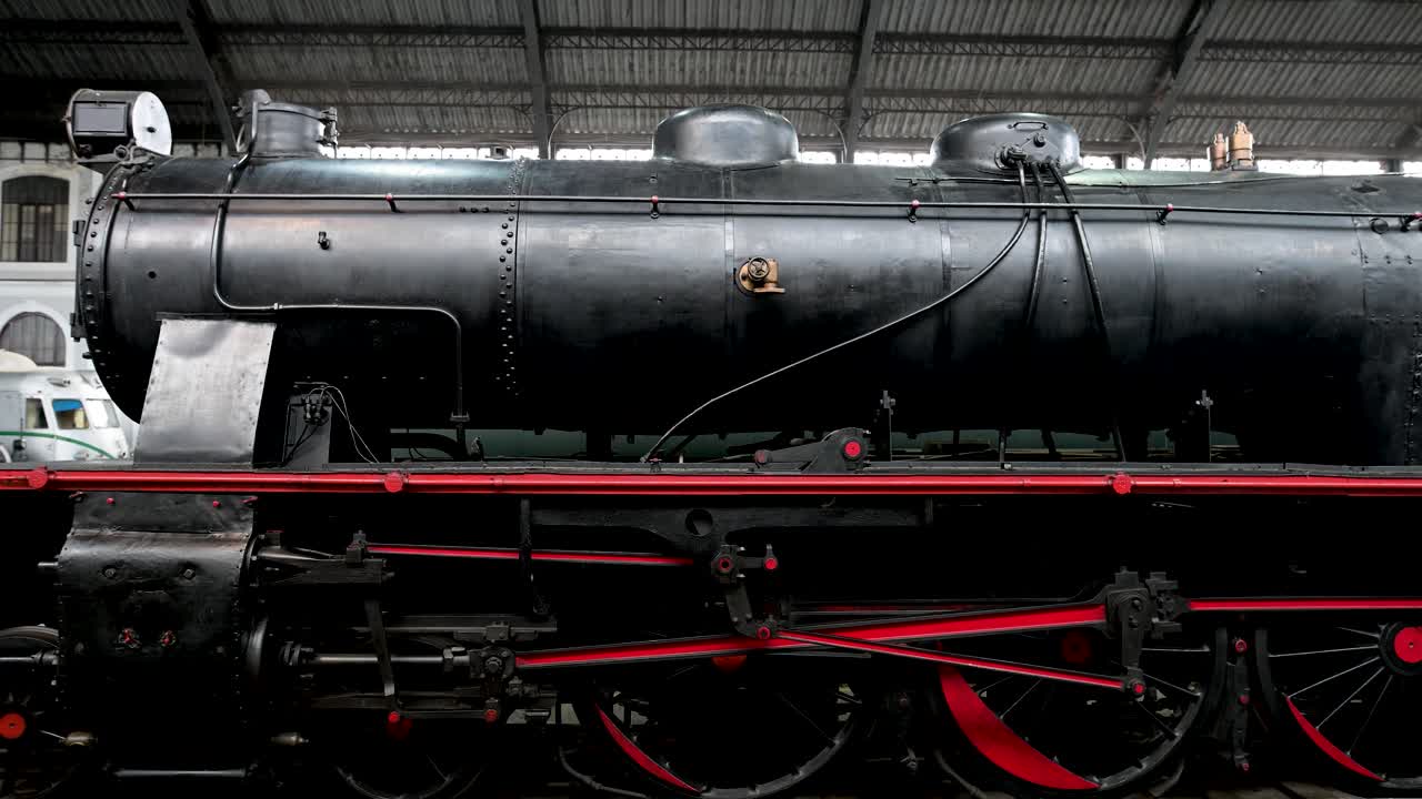Detail of a historic steam locomotive on display at the Railway Museum (Museo del Ferrocarril), a relic of Spain's rich industrial and rail heritage in Madrid, Spain.