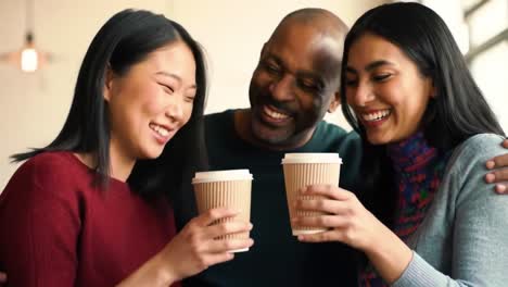 a joyful gathering: three friends sharing warm moments over coffee in a cozy café, featuring smiles, laughter, and connection in a welcoming atmosphere