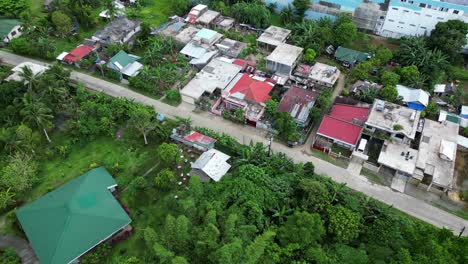 aerial panoramic view of quiet southeast asia roadway with buildins nestled in trees