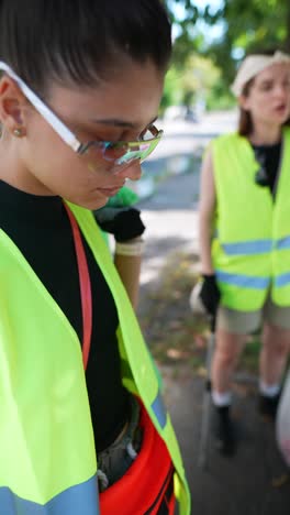 woman street cleaner in fashionable safety gear