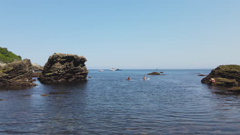 zoom in shot of blue sea with rocky coast