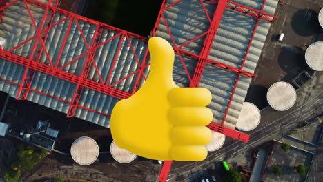 digital composition of thumbs up icon against aerial view of warehouse in the city