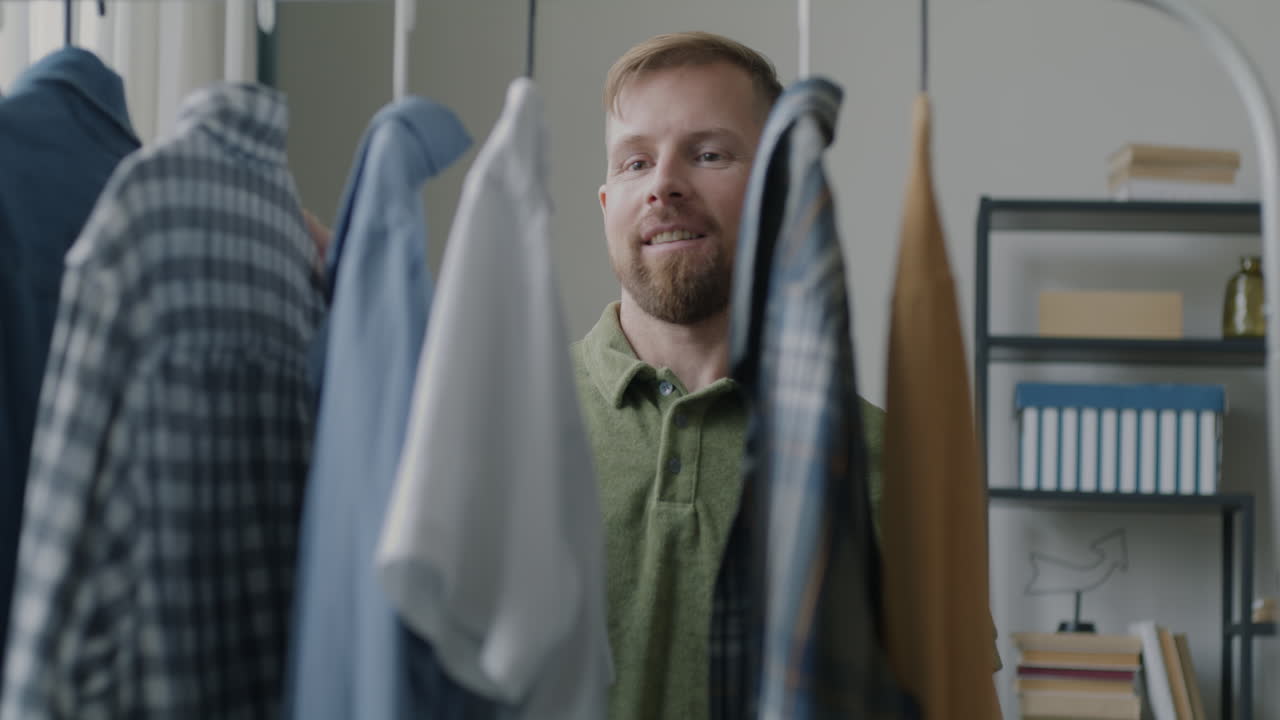 Man choosing clothes from a wardrobe