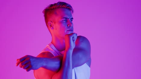 muscular man posing in vibrant lighting