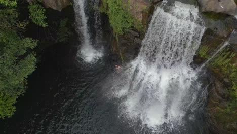 man stand under waterfall