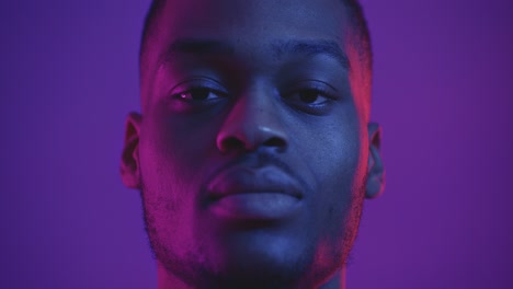 close-up portrait of a man in vibrant lighting