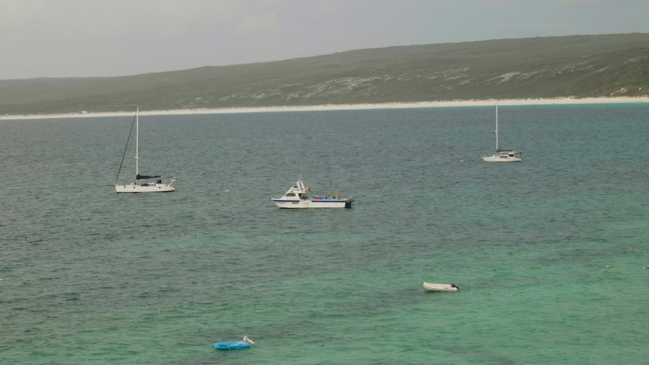 A boat docked at Hamelin Bay, resting peacefully by the shore with calm waters and stunning coastal views.