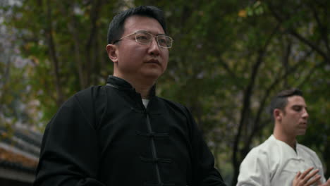 man practicing qigong or tai chi outdoors