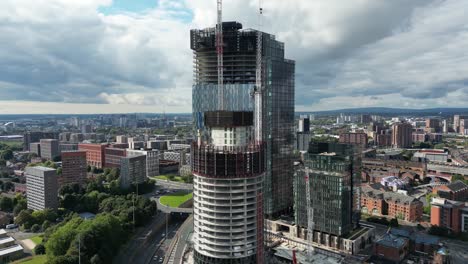 aerial drone flight panning around new skyscraper developments under construction in manchester city centre
