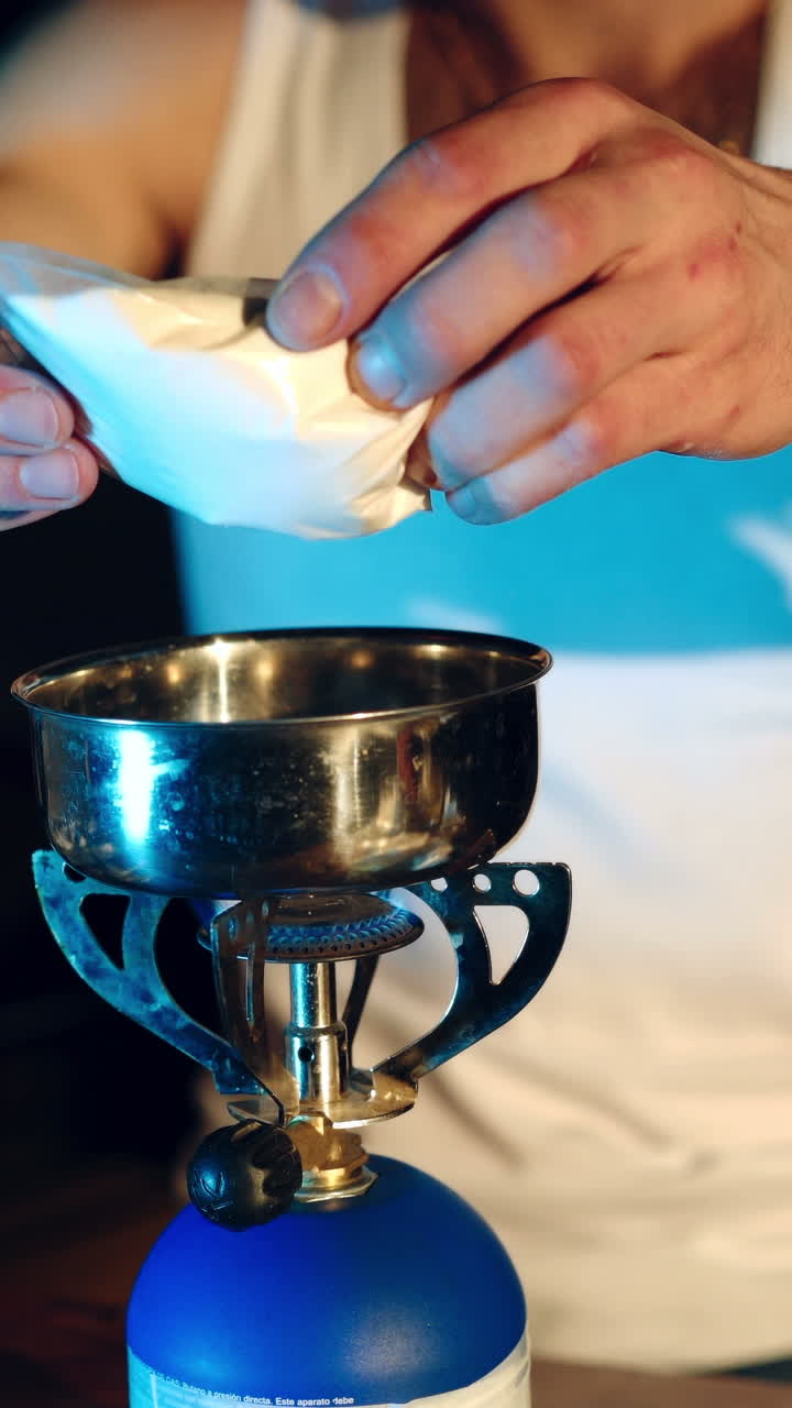 Young man preparing dose of crack cocaine. Concept of drug addiction. Vertical video