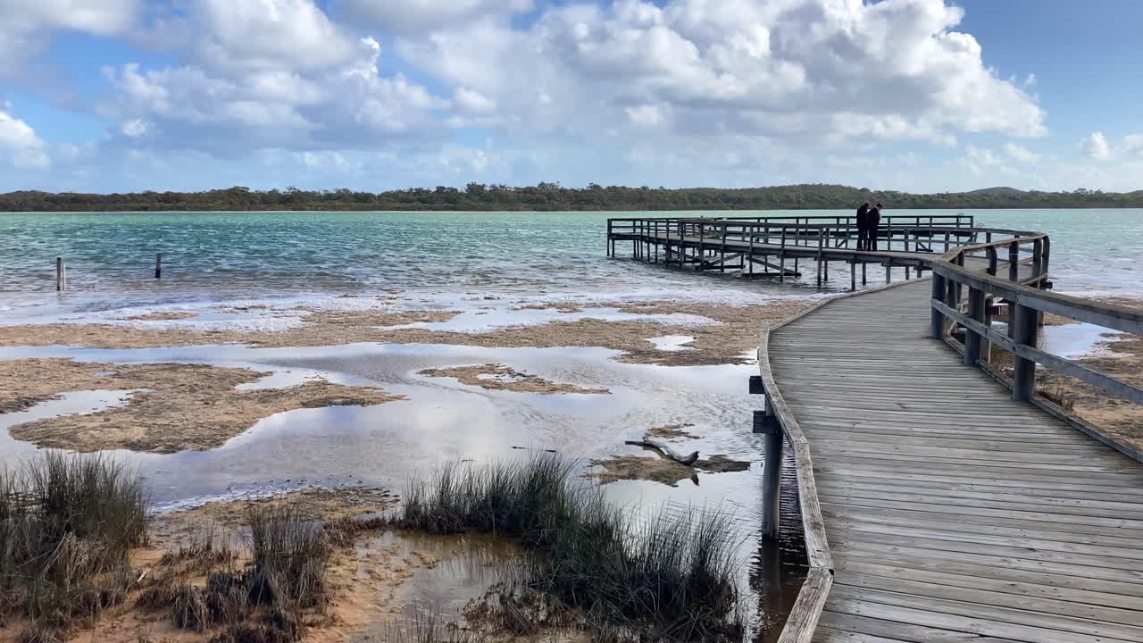 Stromatolite sightseeing by tourists on protected boardwalk in Lake Thetis, Western Australia