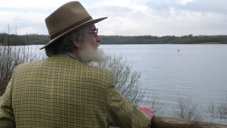 an old man looking out over the lake thinking about history