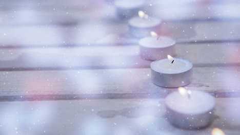 velas combinadas con la nieve que cae