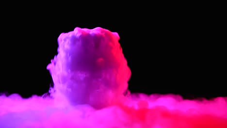 glass with the effect of dry ice with pink light on black background at studio