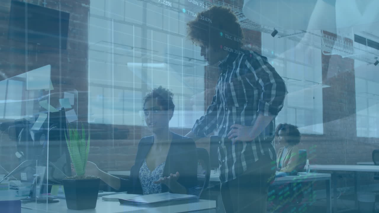 Collaborating at office desk, business professionals using animation for digital data