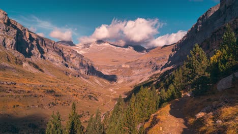 mountain valley timelapse during fall season in ordesa national park beautiful colors and blue sky with white clouds