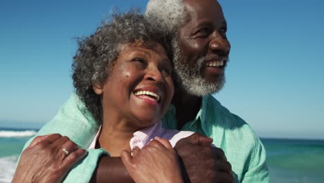 senior couple hugging at the beach