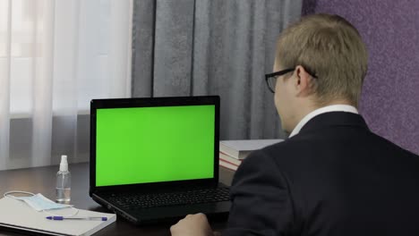 man have video call conference on laptop with green screen. distance work online