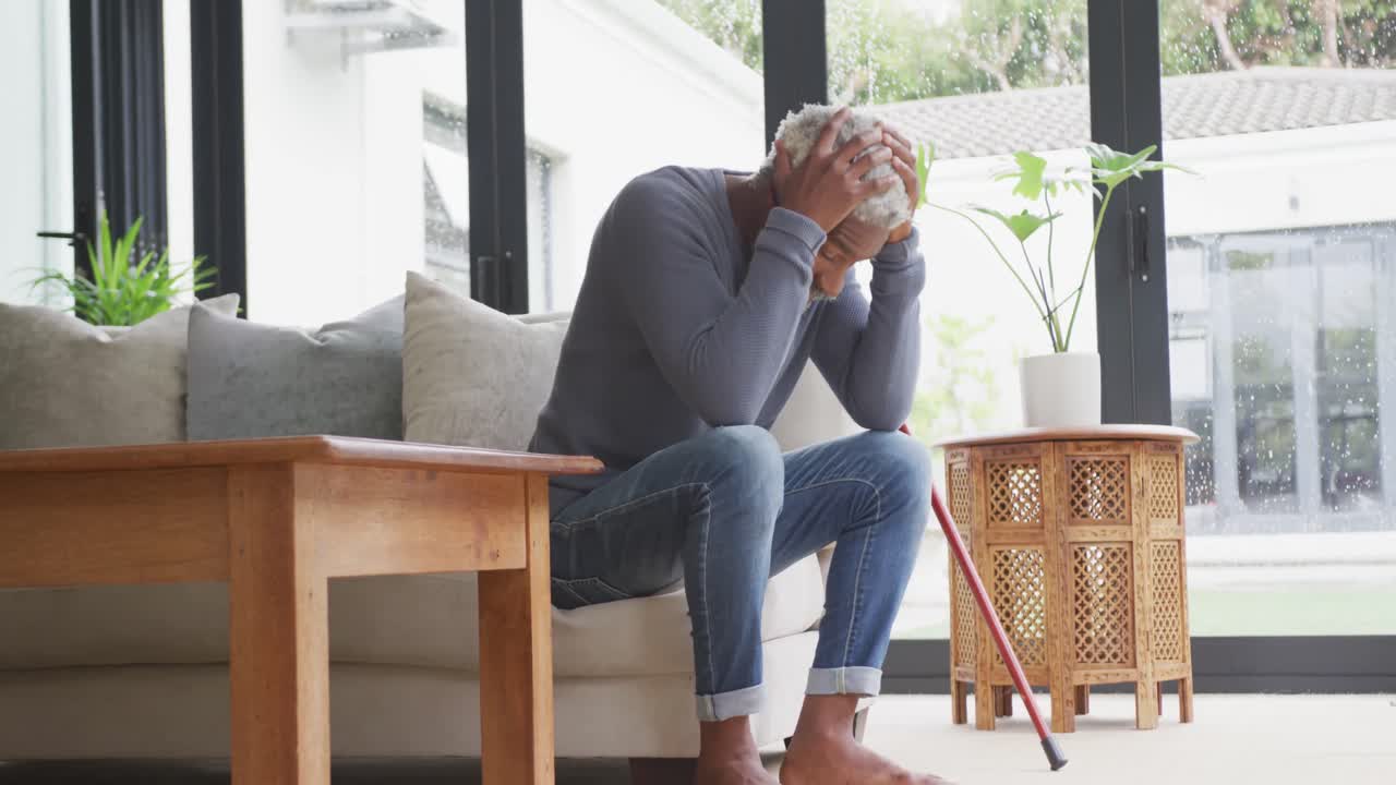Video of sad african american senior man with walking stick