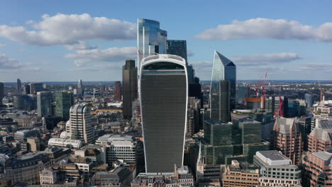 Business-district-with-group-of-tall-modern-glossy-glass-covered-skyscrapers.-Sunny-day-in-City-financial-hub.-London,-UK