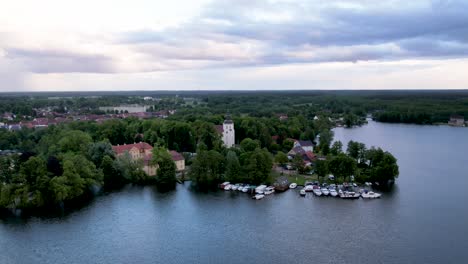 aerial drone timelapse of johanniterkirche church next to a beautiful lake