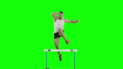 athlete man running and jumping over hurdle