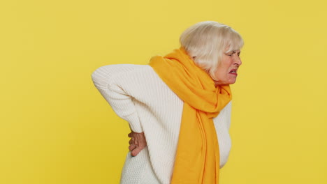 senior old woman touching injured sore back, backache, suffering lower lumbar discomfort muscle pain