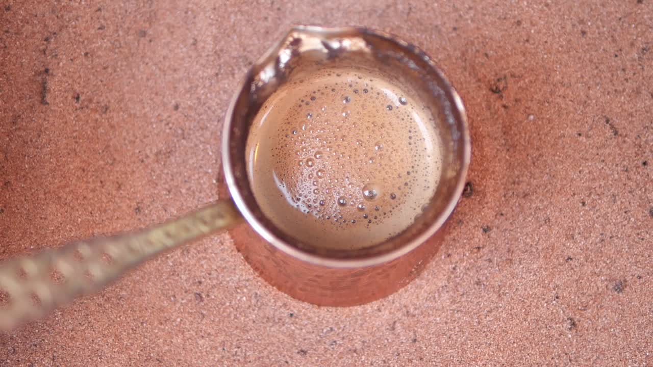 Turkish coffee being prepared in sand