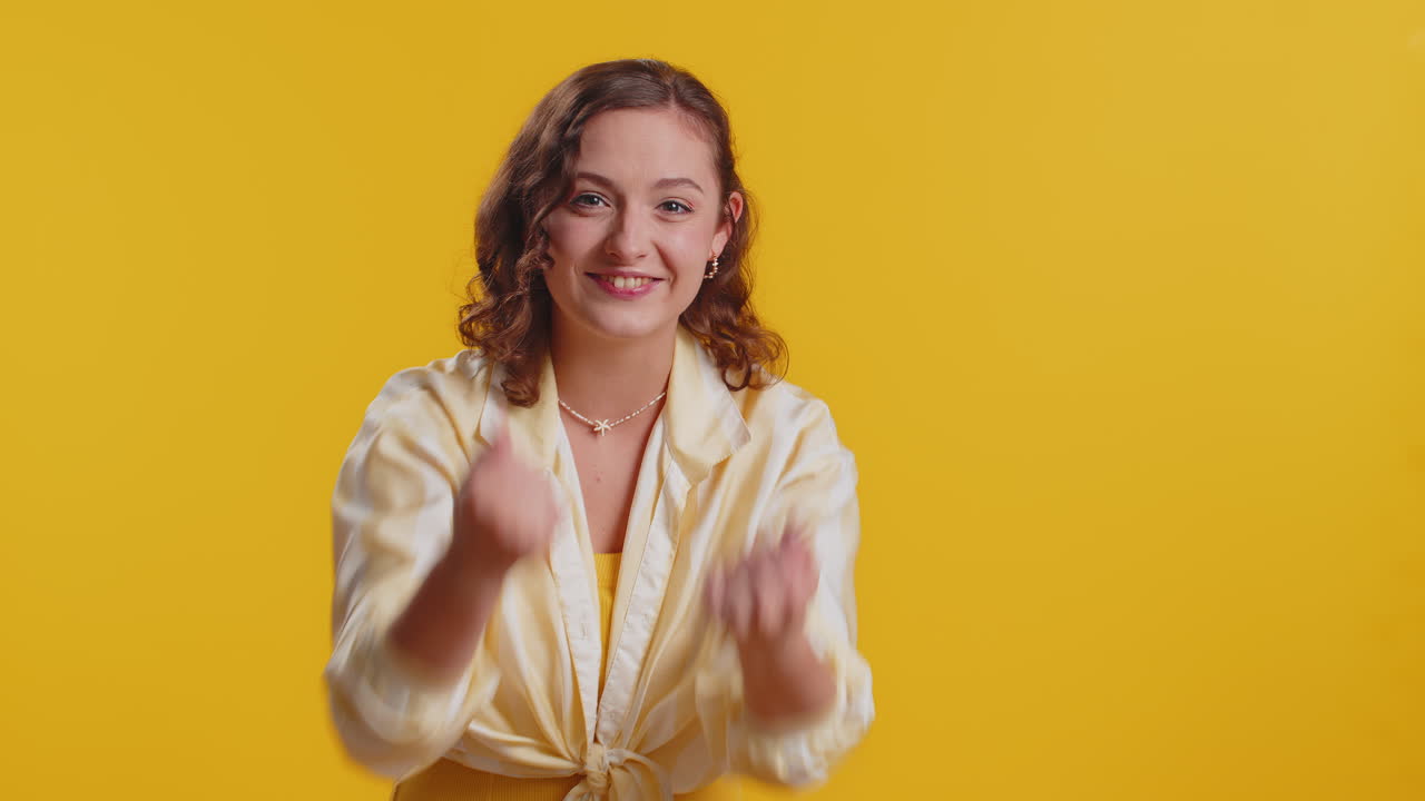 Woman showing inviting gesture with hands ask to join beckoning to coming gesturing hello goodbye