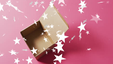 animation of stars falling over christmas box open on pink background