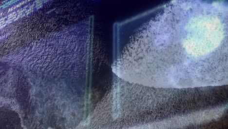 foamy wave crest moving across sandy shoreline, displaying neon light streak overlays in 3d render