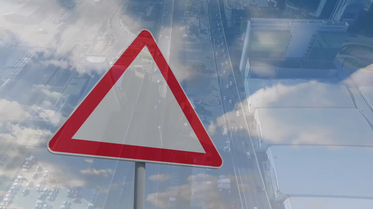 Traffic warning sign animation over aerial view of cityscape with clouds