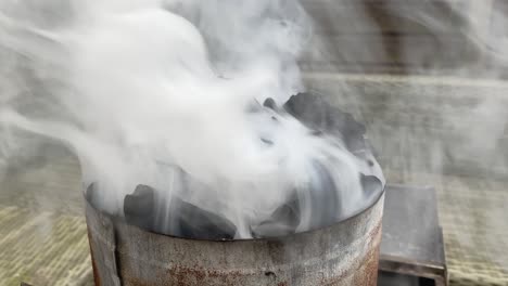 a lot of smoke coming out of a barbecue charcoal starter