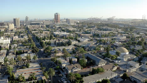 aerial view of a coastal city with residential areas and a distant port