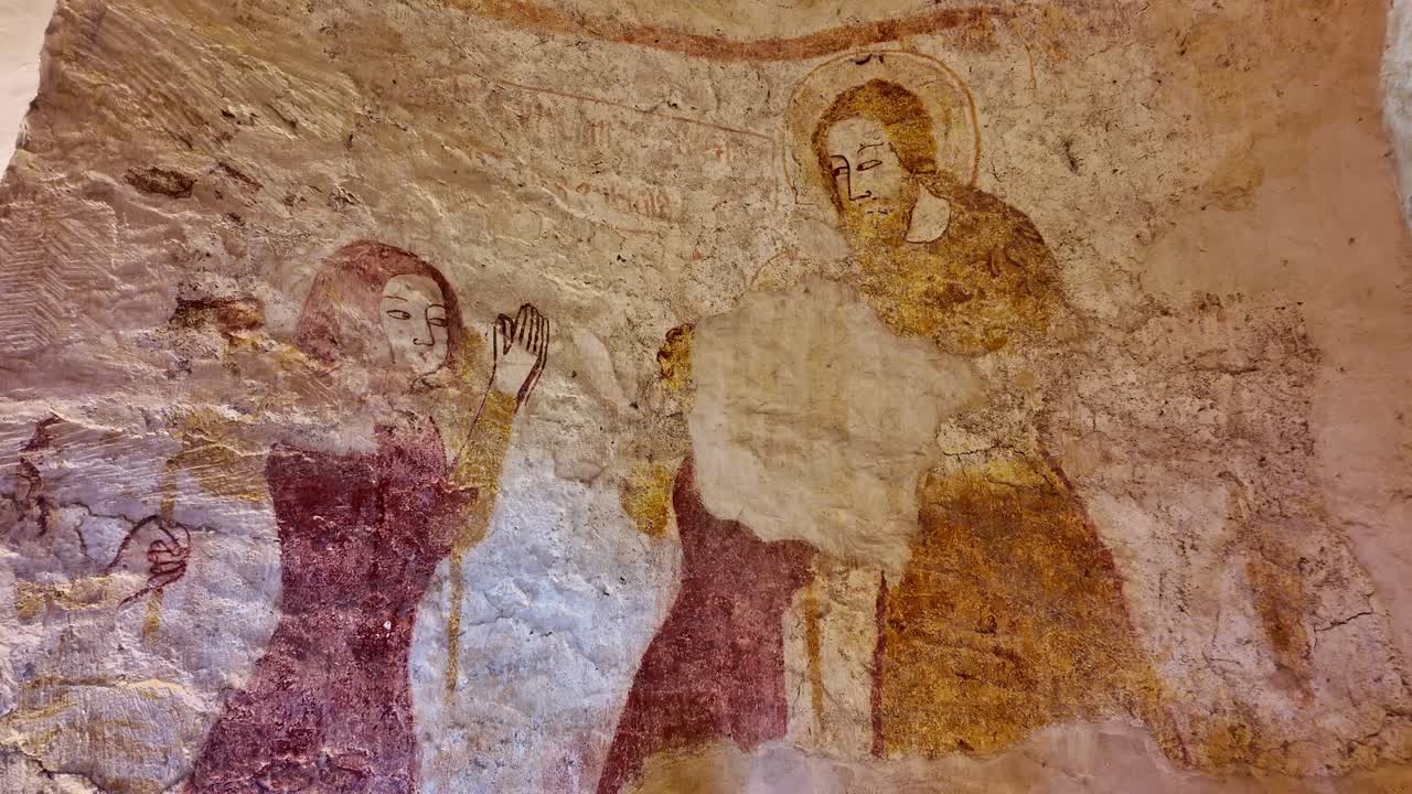 Jesus blessing woman on a wall painting of biblical figures