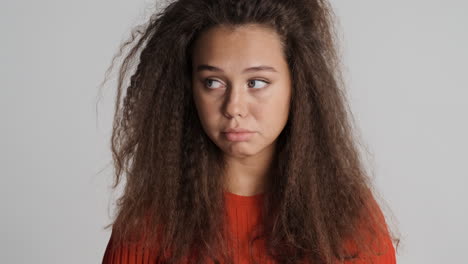 sad caucasian curly haired woman.