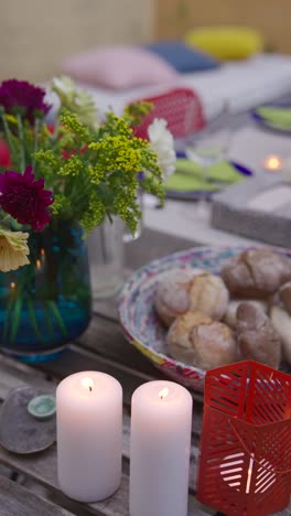 outdoor patio dinner setting with flowers and candles
