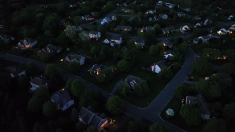 aerial top down of quiet residential area with lighting streetlights after sunset. night scene in upper class suburbia in usa. row of houses and mansion lighting in spring. va, united states.