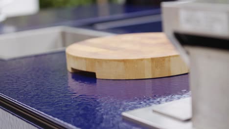 Wooden-chopping-board-on-outside-kitchen-surface