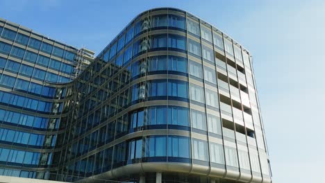 modern business office building with windows on sunny day against sky - aerial view