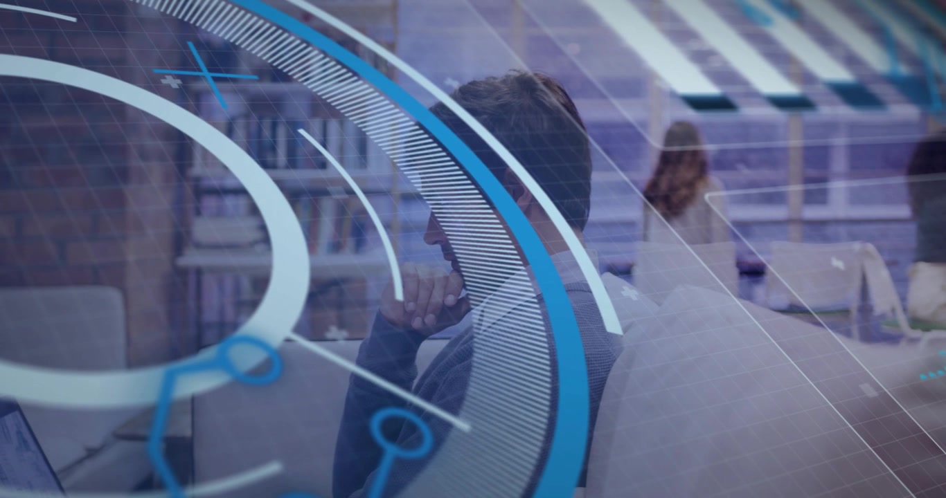 Seated man using laptop in library, HUD overlay sweeping and revealing profile for education
