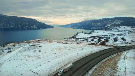 winter journey along okanagan highway 97 and wood lake in kelowna, central okanagan: cars and semi trucks on the move