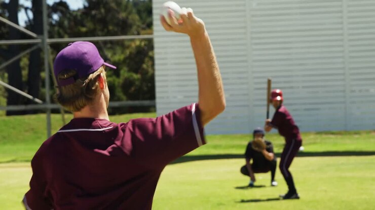 Baseball players pitching ball during practice session
