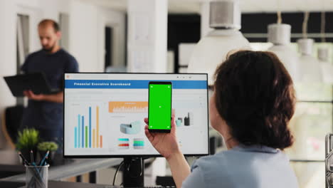 employee uses phone app with greenscreen