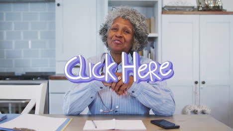female health worker sitting at table, showing stethoscope and notebook with click here overlay