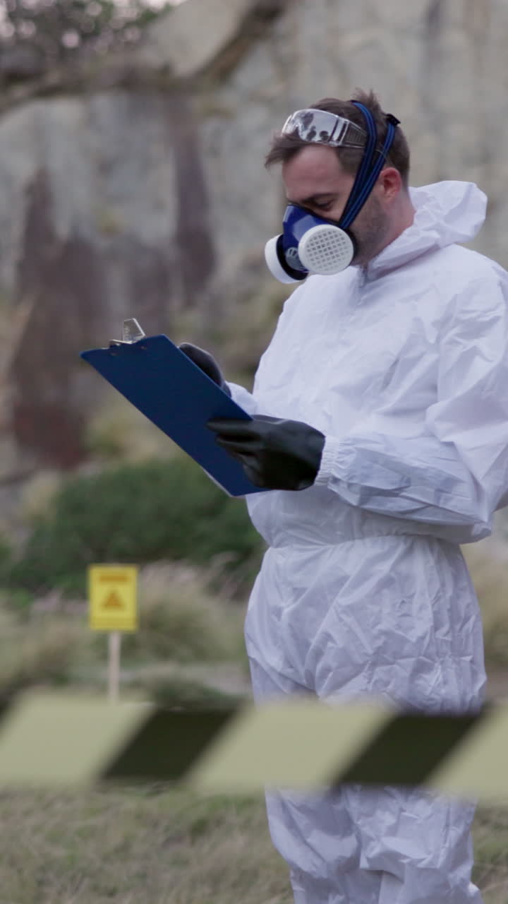 Researcher in Hazmat Suit Taking Notes